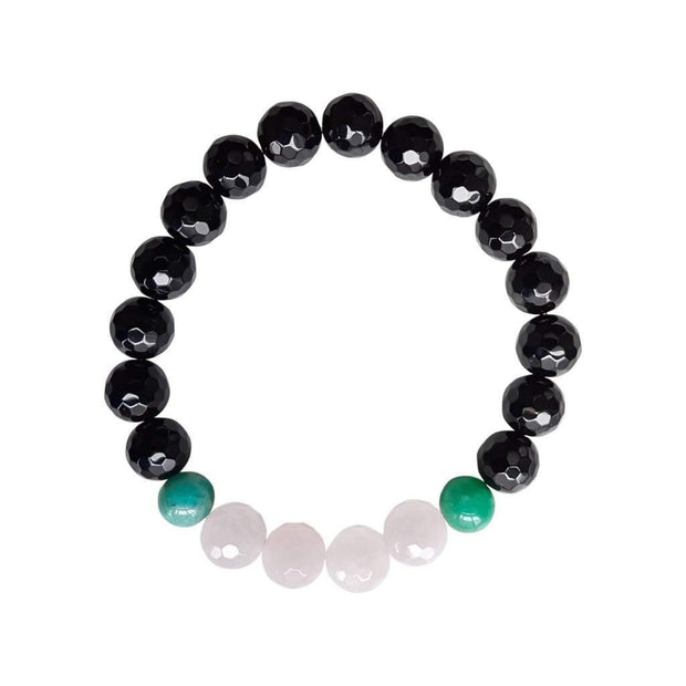 Close up on a white background of a faceted gemstone bracelet. There are four rose quartz beads in between two dark green amazonite beads. The rest of the bracelet is black onyx beads.